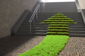 Treppe mit einem grünen Rasenstreifen mit Pfeilspitze, der eine graue Treppe hinauf führt 